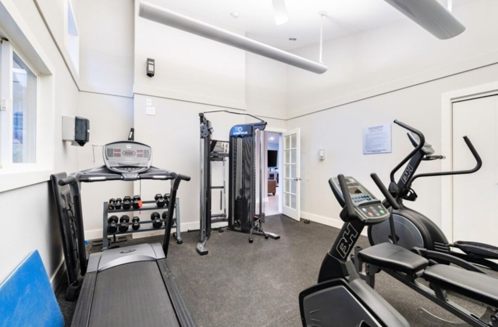 a gym with exercise equipment and a window