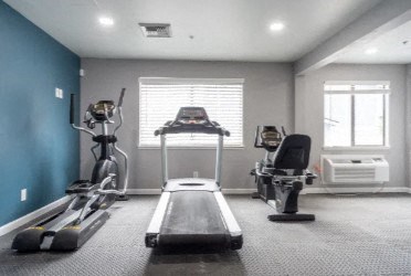 a gym with exercise equipment and a window