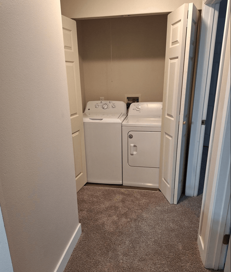 a washer and dryer in a room with a door