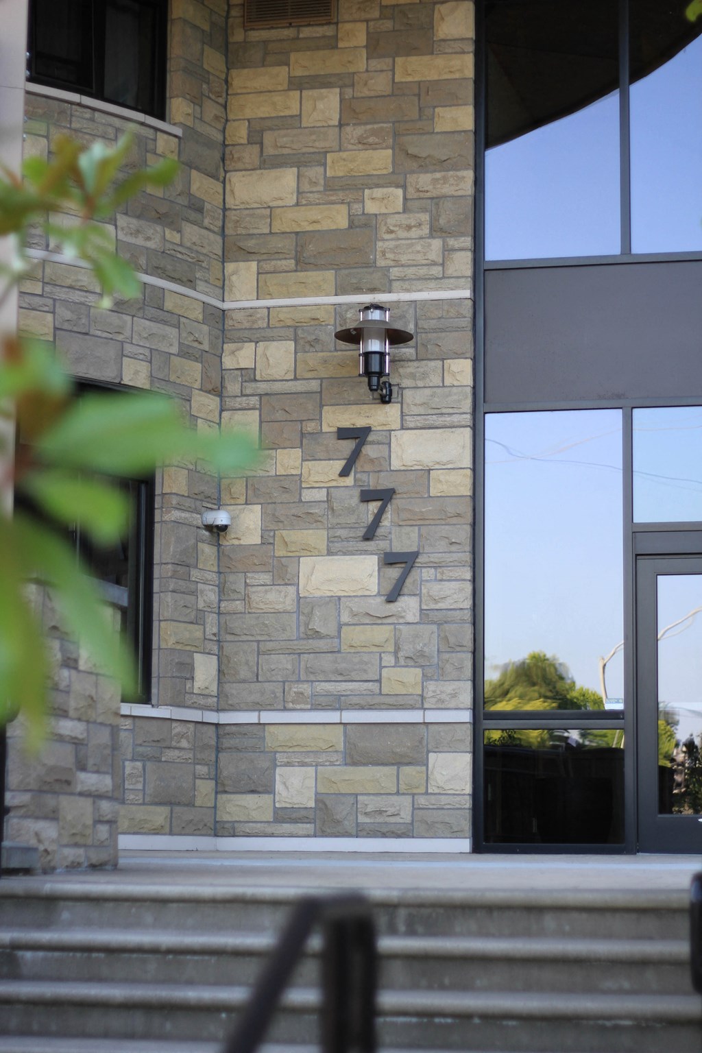 the facade of a building with stone bricks and a glass door