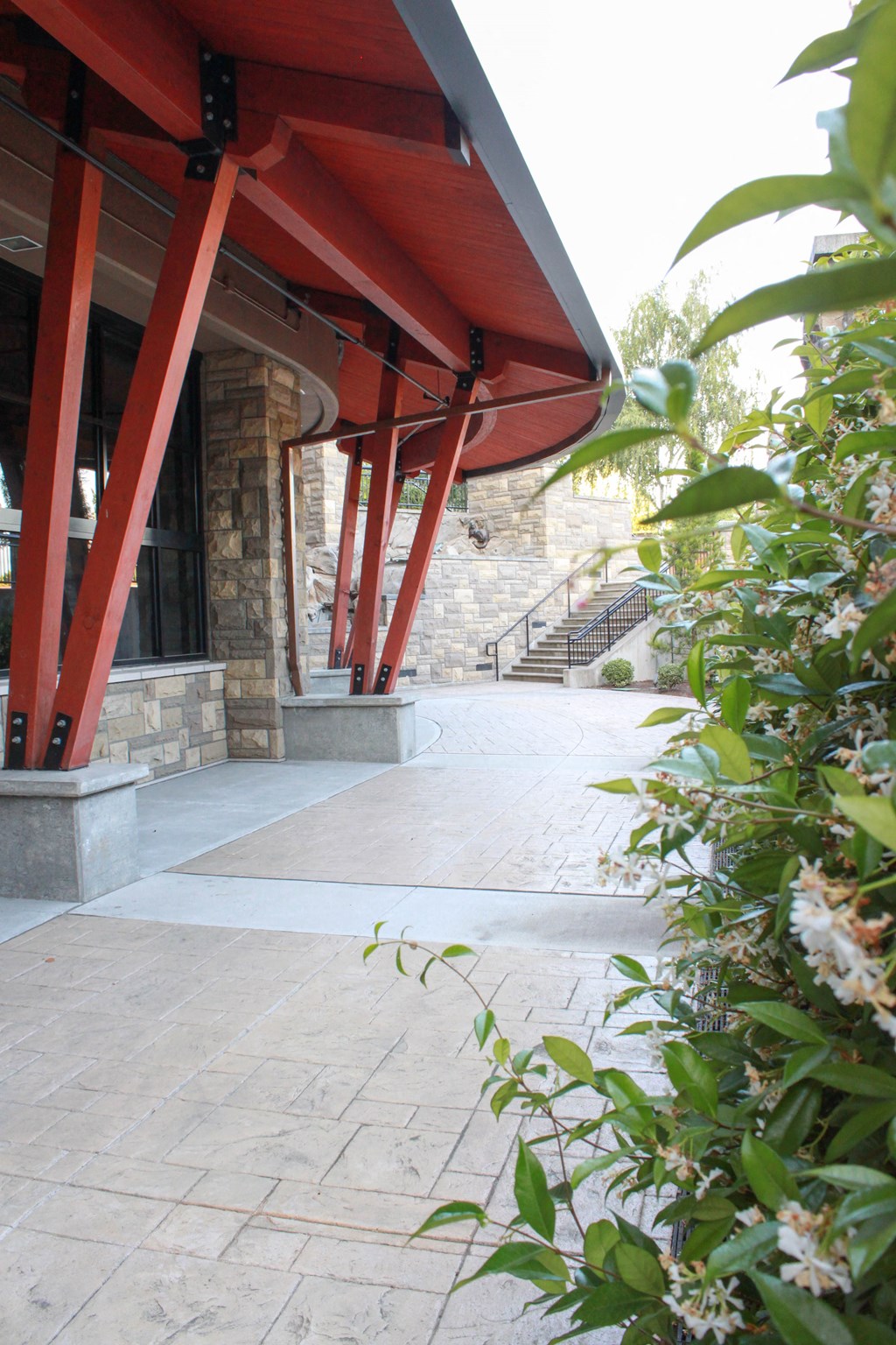 a view of the front of a building with red beams