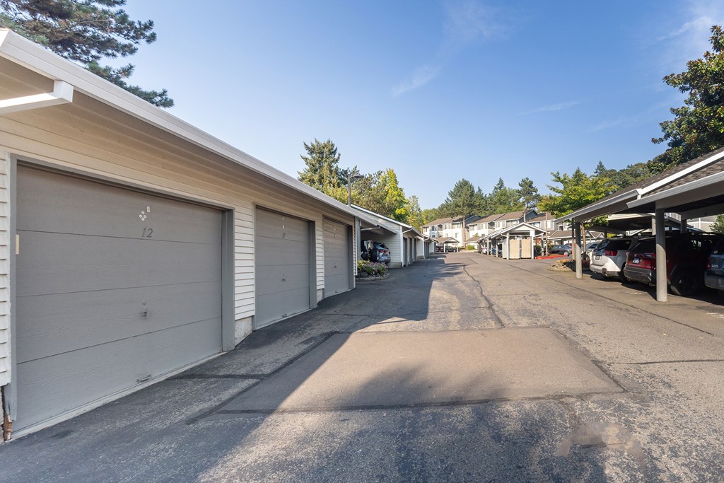 A row of garage doors on a sunny day.