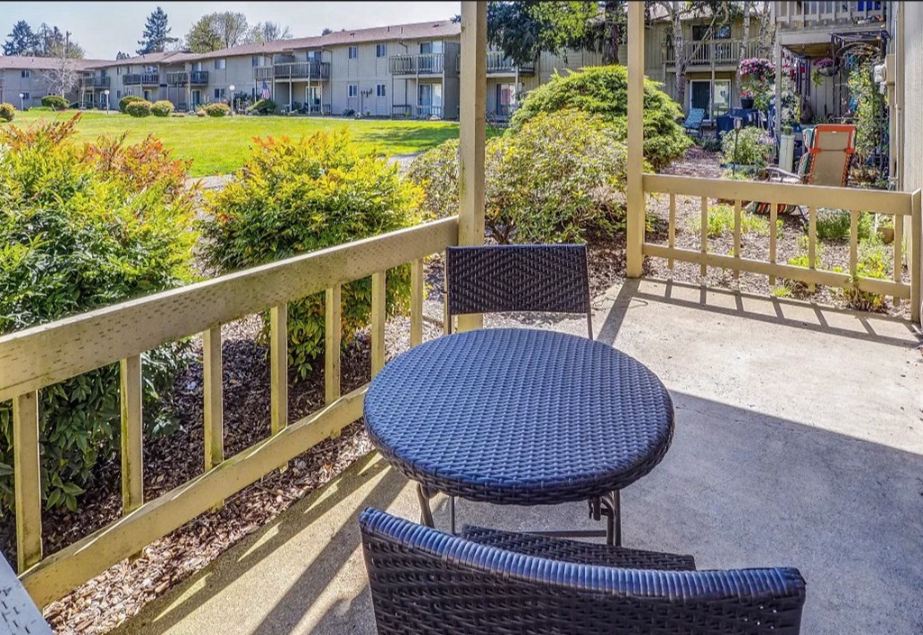 a patio with a table and chairs on a balcony