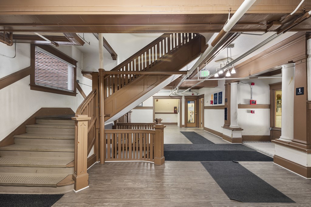 the lobby of a building with a staircase in the center