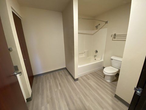 A bathroom with a toilet, sink, and shower.