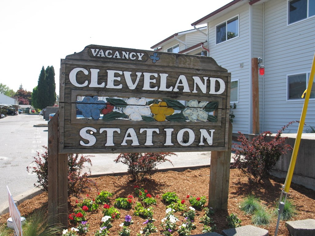 a sign for the station in front of a house