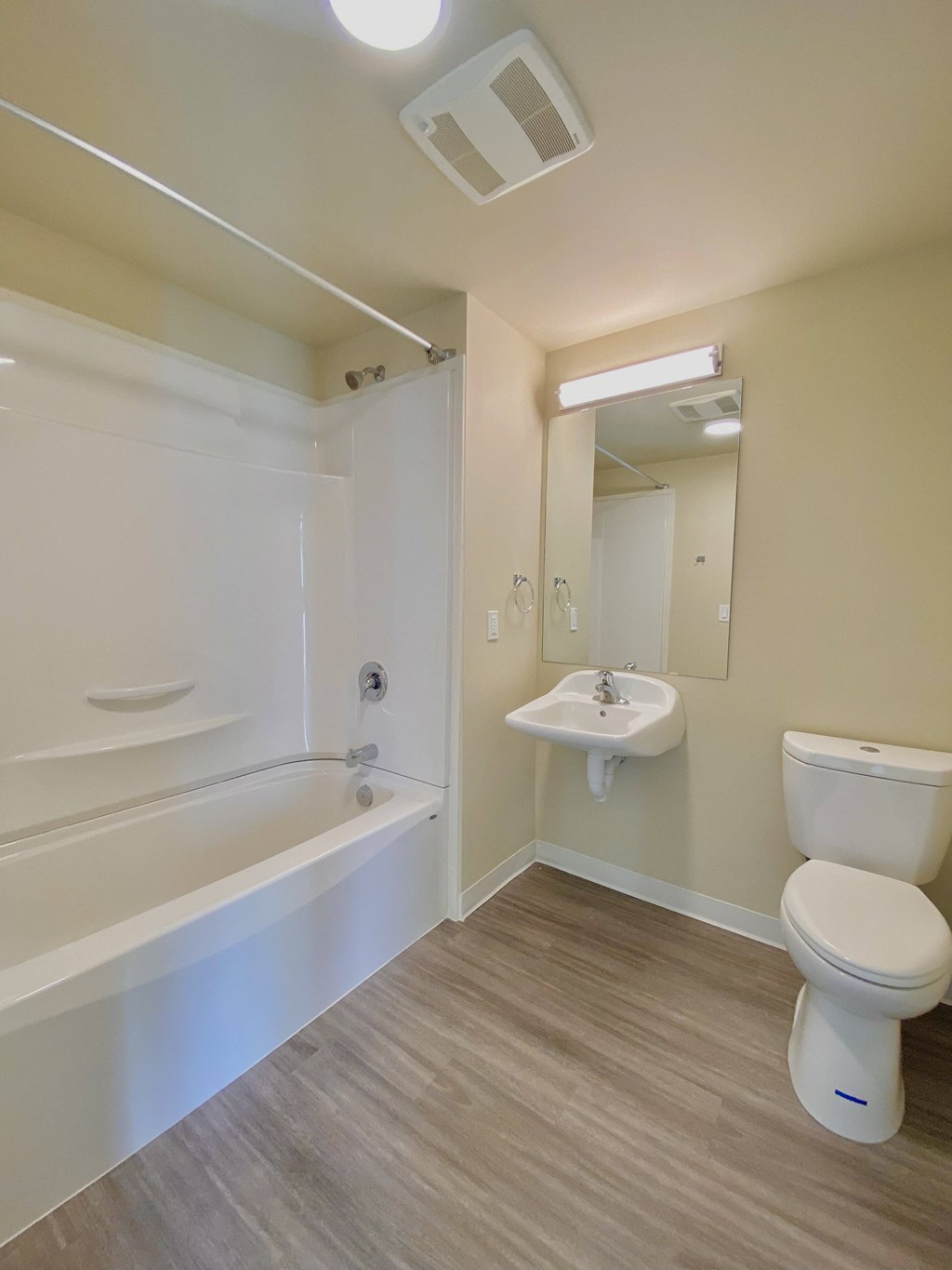 a bathroom with a toilet and a sink and a bath tub