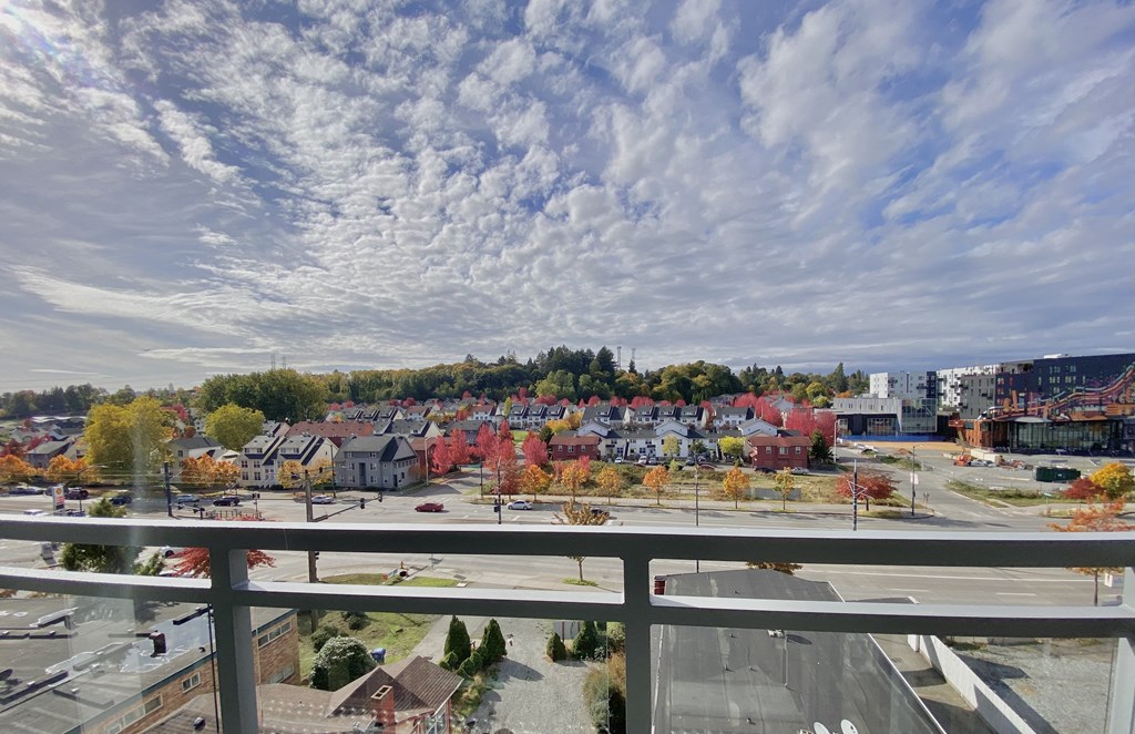 a view of a city from a balcony on a cloudy day
