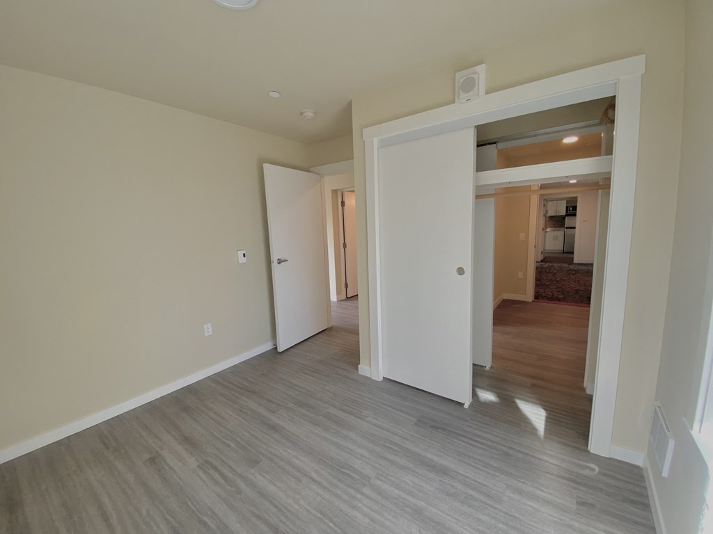 a view of the living room and bedroom from the entryway of a new home