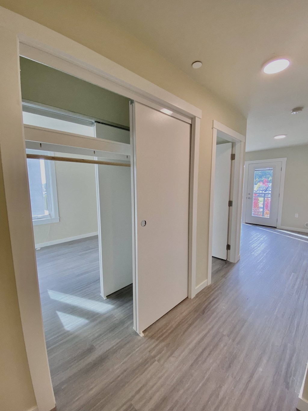 an empty room with white walls and sliding closet doors