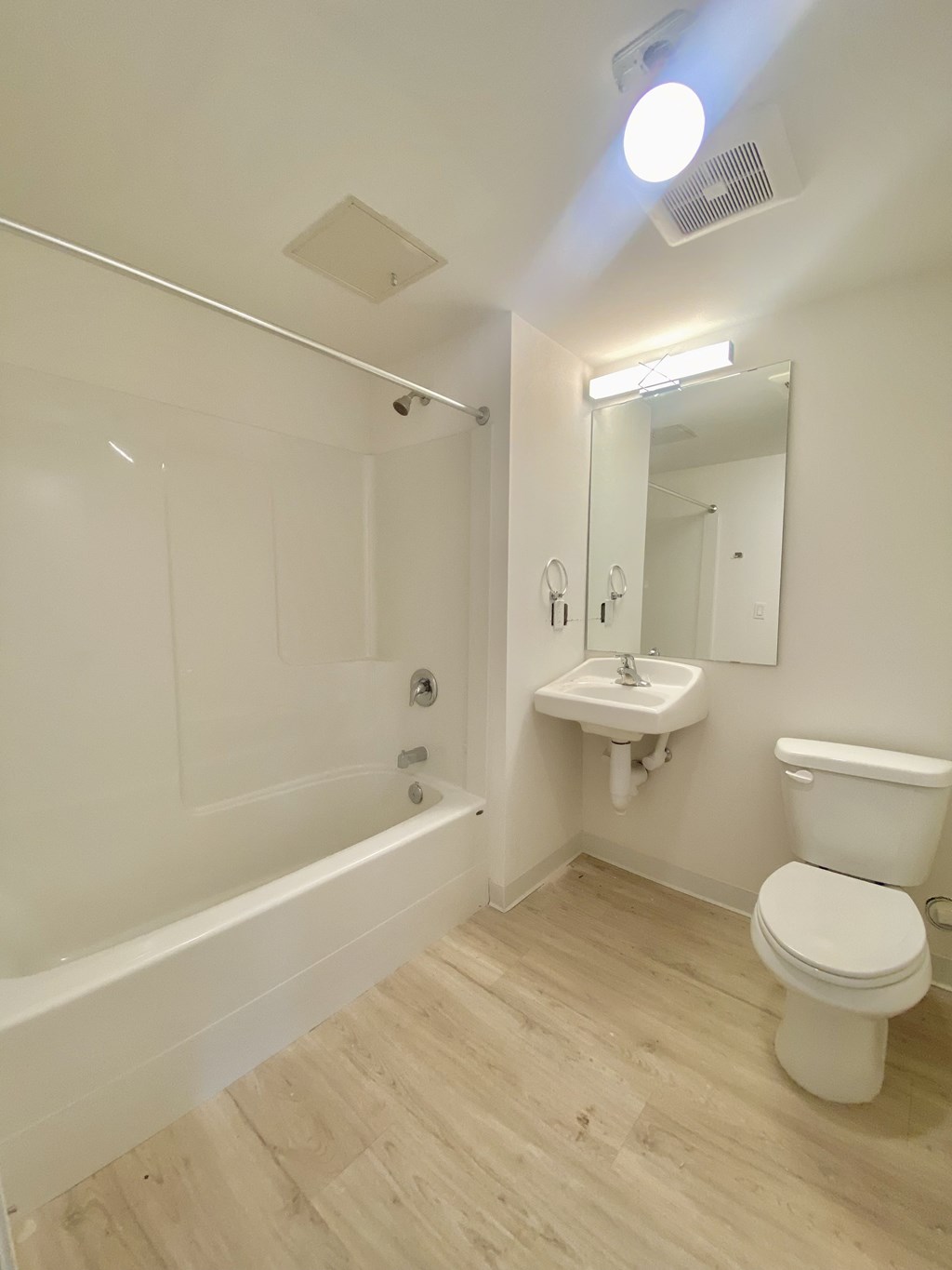 a bathroom with a toilet and a sink and a bath tub