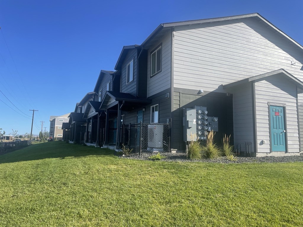 a row of houses with a yard in front of them