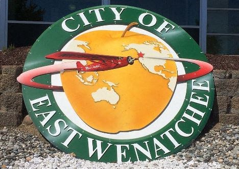 a sign for the city of asuncion sits on the ground