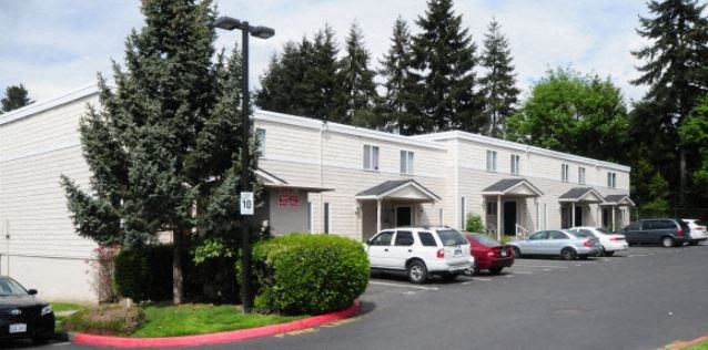 a white building with cars parked in front of it