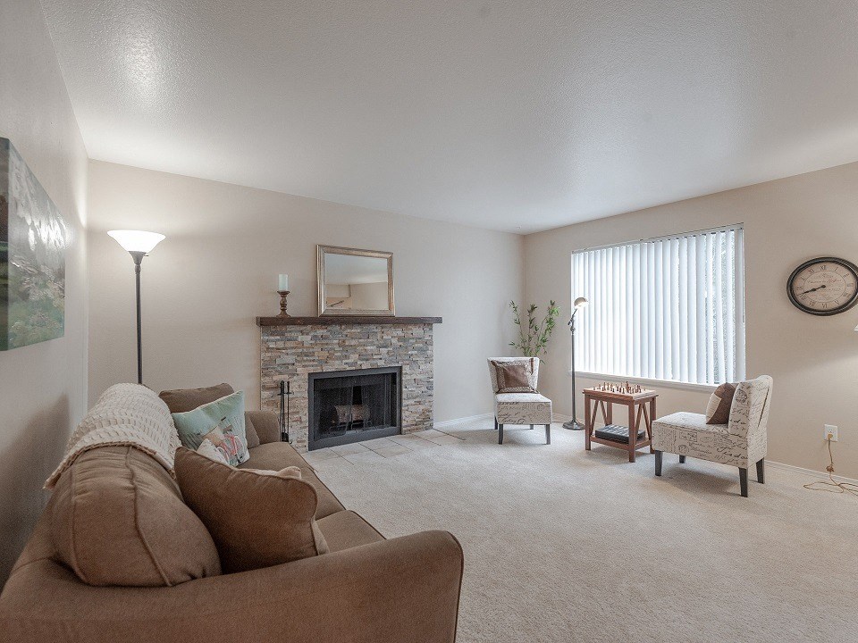 an open living room with a couch and a fireplace