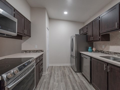a kitchen with stainless steel appliances and wooden cabinets