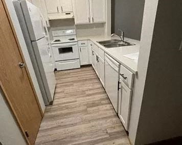 a small kitchen with white cabinets and white appliances