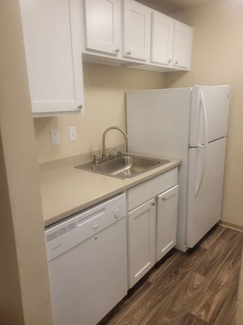 a kitchen with a sink and a refrigerator