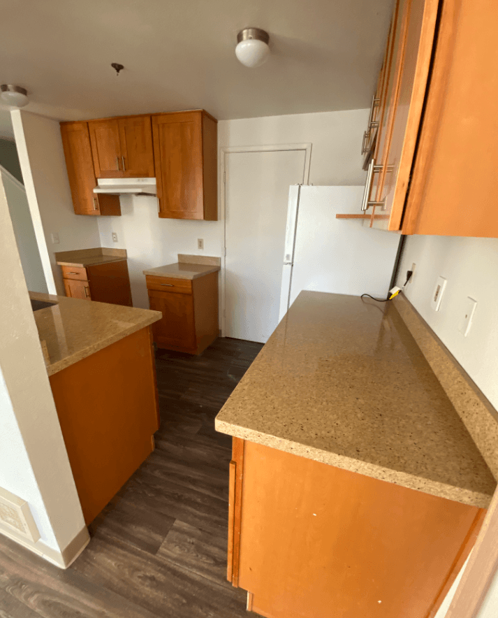 a kitchen with a counter top and a refrigerator
