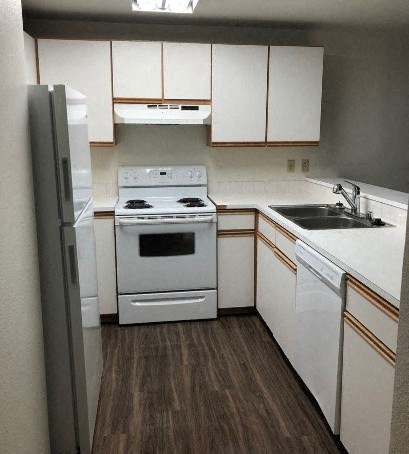 A white stove and dishwasher in a kitchen.
