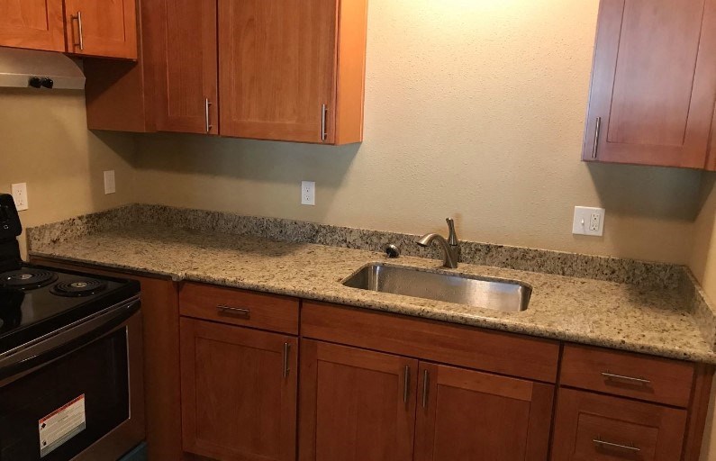 a kitchen with a granite counter top and a sink