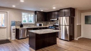 a kitchen with stainless steel appliances and a marble counter top