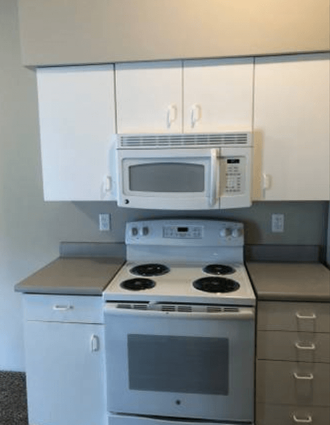 a kitchen with a stove and a microwave