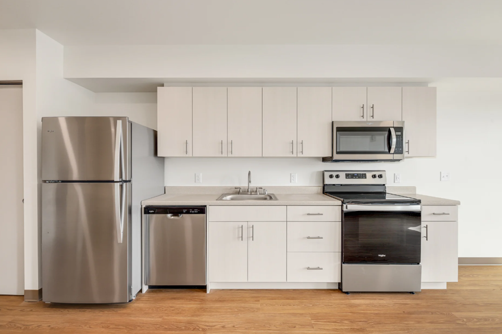 a kitchen with stainless steel appliances and white cabinets