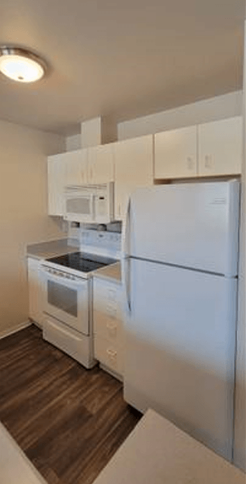 a kitchen with a refrigerator and a stove