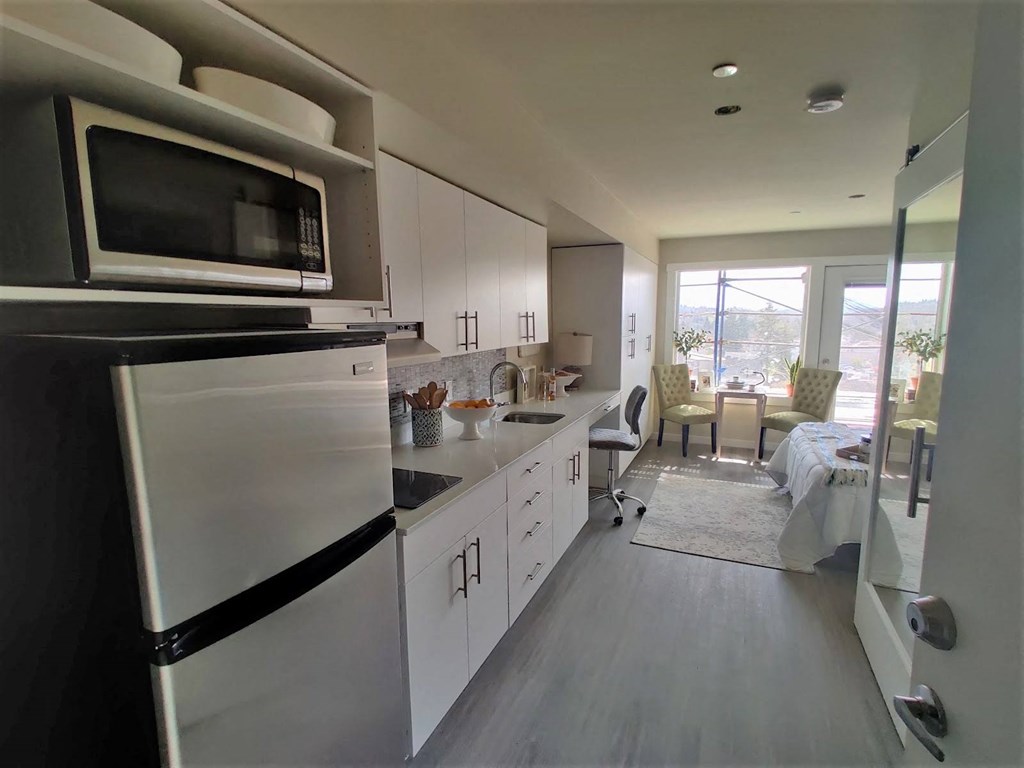 a kitchen with a refrigerator and a microwave