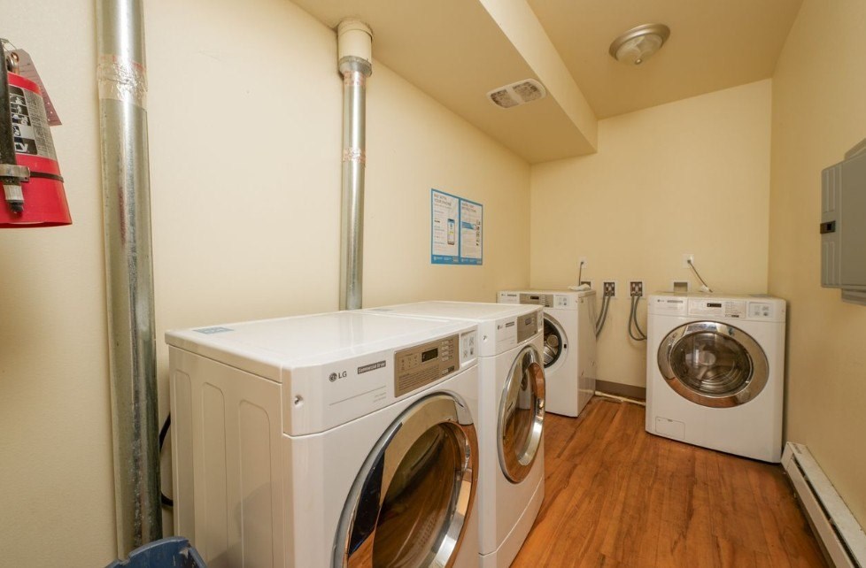 A row of washing machines in a laundry room.