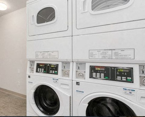 a row of washing machines in a laundry room