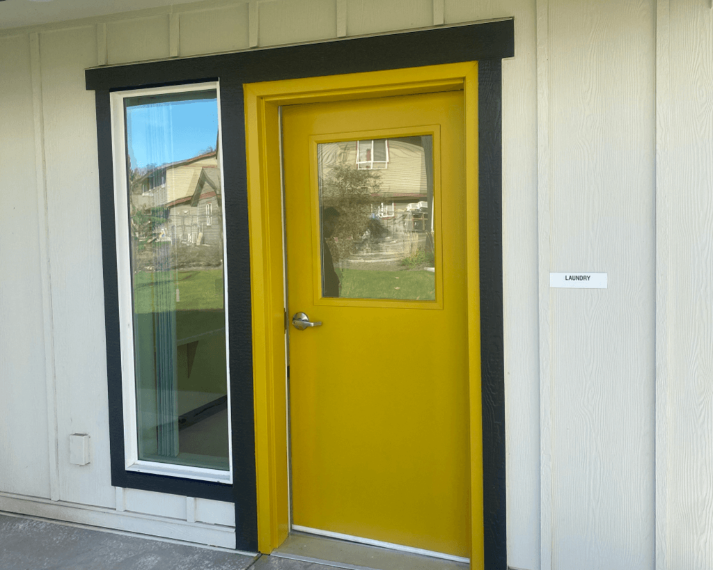 a yellow door with a window on a building