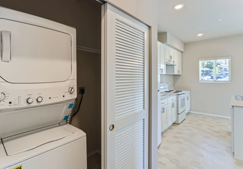 A white washing machine and dryer in a laundry room.