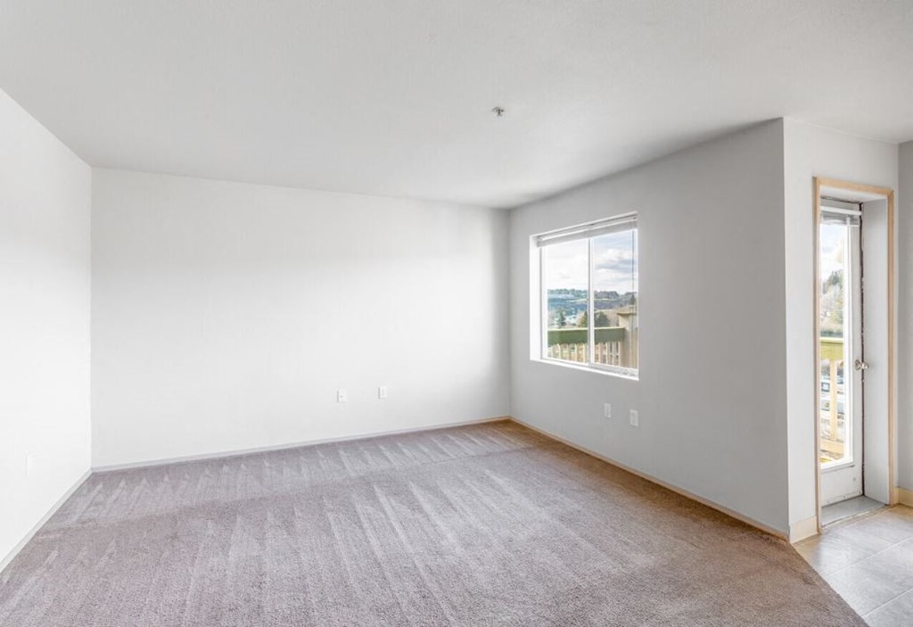 the living room of an empty house with a window