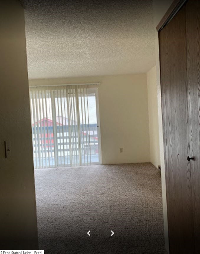 an empty living room with a sliding glass door