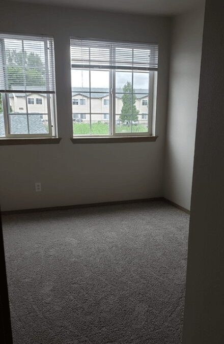 an empty room with three windows in it