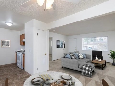 A living room with a grey couch and a coffee table.
