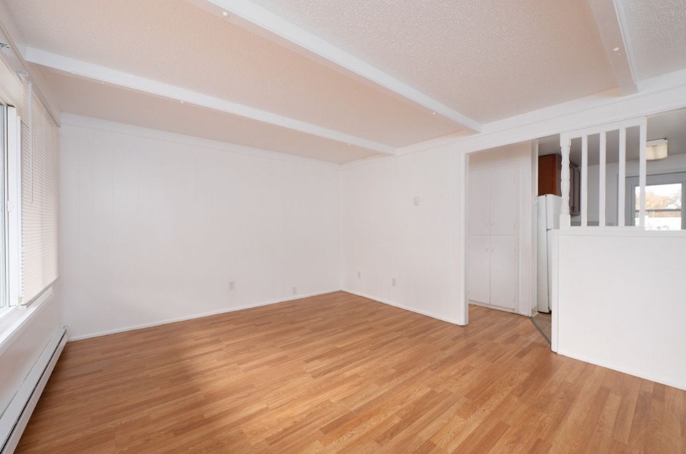 A room with wooden floors and white walls.