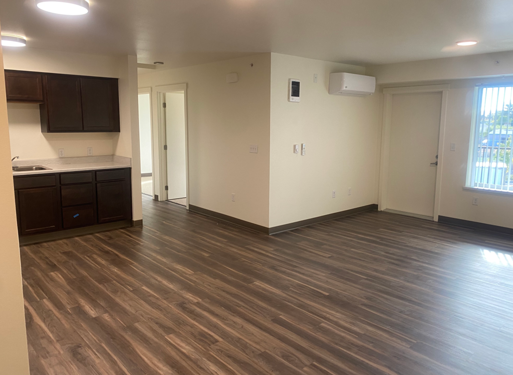 a kitchen and living room in an empty apartment