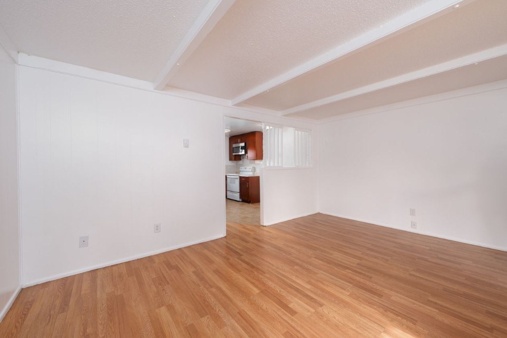 A room with wooden floors and white walls.