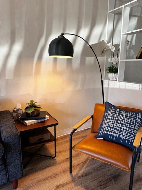 A living room with a grey couch and a television.