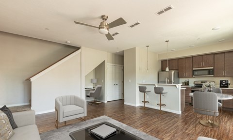 A modern open plan living and kitchen area with a staircase.