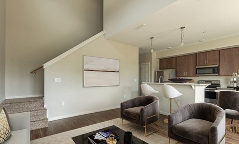 A living room with a grey couch and a coffee table.