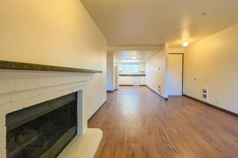 a living room with a fireplace and a wooden floor