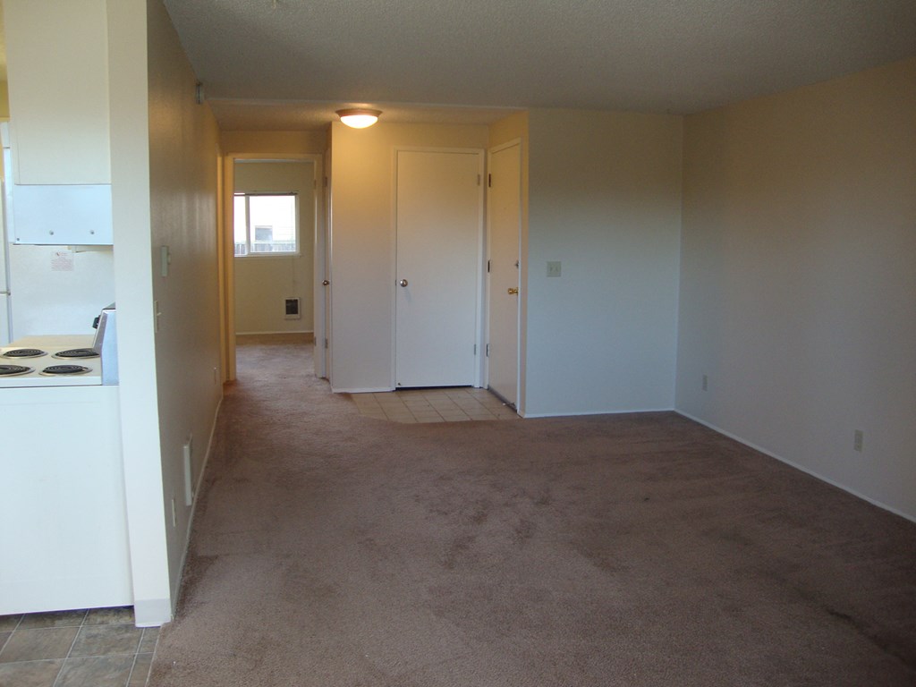 A room with carpeted floor and white walls.