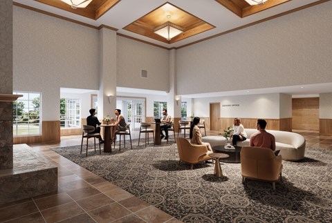 A group of people are sitting in a spacious lobby with a patterned carpet.