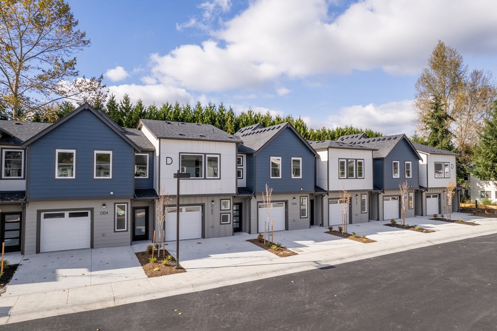 A row of houses with garages in front of them.