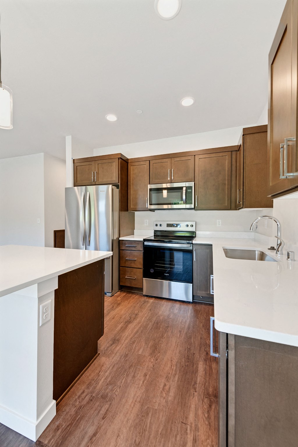 a kitchen with wooden cabinets and stainless steel appliances