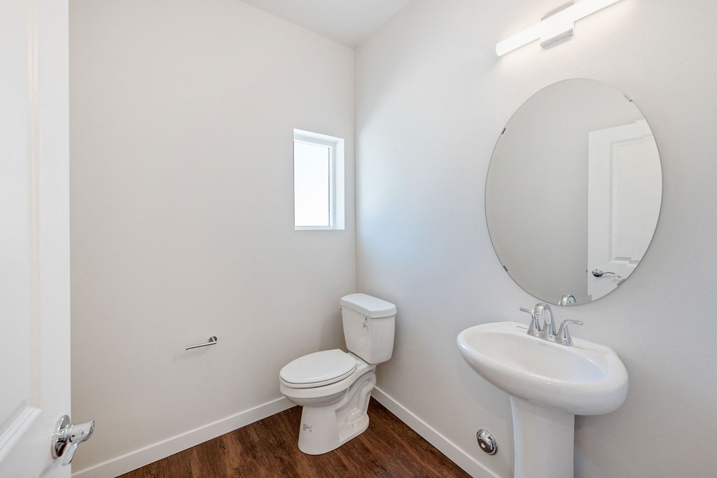 a bathroom with a toilet and a sink and a mirror